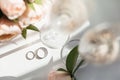 Wedding rings lie next to two glasses of champagne and a bouquet of roses Royalty Free Stock Photo