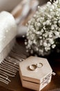 Wedding rings lie on a wooden box Royalty Free Stock Photo