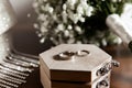 Wedding rings lie on a wooden box Royalty Free Stock Photo