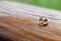 Wedding rings on a light wooden texture. Wedding jewelry.