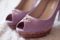 Wedding rings on lilac suede shoes