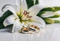 Wedding rings and lilies Royalty Free Stock Photo