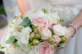 Wedding rings lying on a bouquet in the hands of the bride. Background for weddings and ceremonies