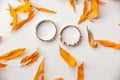 Wedding rings with orange dried flower petals