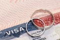 Wedding rings on passport with us visa as concept of marriage of convenience