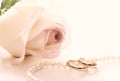Wedding rings, pearl beads and rose Royalty Free Stock Photo