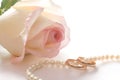 Wedding rings, pearl beads and rose, isolated Royalty Free Stock Photo