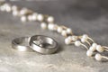 Wedding rings and pearl necklace Royalty Free Stock Photo