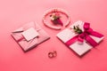 wedding rings, pearl necklace, boutonniere and pink envelopes with invitations Royalty Free Stock Photo