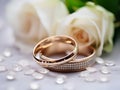 Wedding rings from red gold and diamonds with bouquet of pink roses. Gold wedding rings. Luxury rings for wedding, proposal. Saint Royalty Free Stock Photo