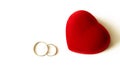 Wedding rings and red heart-shaped jewelry box Royalty Free Stock Photo