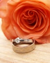 Wedding rings on a red rose