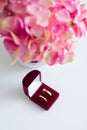 Wedding rings in a red velvet box and a bridal bouquet over a white table - flat lay top-down composition Royalty Free Stock Photo