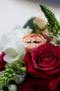 Wedding rings on a rose flower in a bouquet Royalty Free Stock Photo