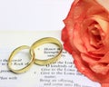 Wedding rings on an open bible passage about honour and strength in the Lord Royalty Free Stock Photo