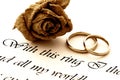 Wedding rings, rose and vow