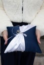 wedding rings on small blue white cushion pillow with ribbon in bride hands Royalty Free Stock Photo