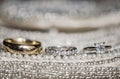 Wedding rings on sequins and pearls Royalty Free Stock Photo