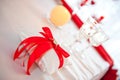 Wedding rings tied with a red ribbon with a heart on a pad shot against the background of two glasses of champagne Royalty Free Stock Photo