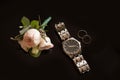 Wedding rings watch and boutonniere on background. Flat lay Royalty Free Stock Photo