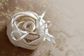 Wedding rings on white beautiful cushion in the form of a rose Royalty Free Stock Photo