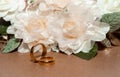 Wedding rings this white flowers in the background beautifully arranged Royalty Free Stock Photo