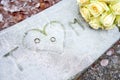 Initials, wedding rings and white roses on a frozen surface Royalty Free Stock Photo