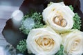 Wedding rings and white roses Royalty Free Stock Photo