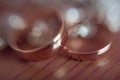 Wedding rings on wooden background with bokeh closeup Royalty Free Stock Photo