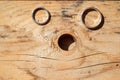 Wedding rings on a wooden board next to a hole Royalty Free Stock Photo