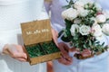 Wedding rings in a wooden box filled with moss on the green grass Royalty Free Stock Photo