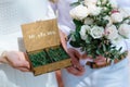 Wedding rings in a wooden box filled with moss on the green grass Royalty Free Stock Photo