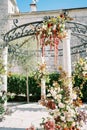 Wedding rotunda decorated with flowers near an ancient house Royalty Free Stock Photo