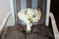 Wedding rustic bouquet on vintage striped chair. Bridal room interior.