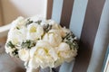 Wedding rustic bouquet on vintage striped chair. Bridal room interior.