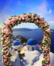 Wedding at Santorini. Beautiful arch decorated with flowers of roses with blue church of Oia, Santorini, Greece at most romantic