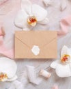 Blank sealed envelope near white orchid flowers and silk ribbons on marble, mockup