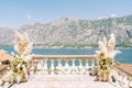 Wedding semi-arch on an antique marble balustrade overlooking the sea