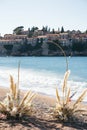 Wedding semi-arch on the seashore against the backdrop of the island of Sveti Stefan. Montenegro