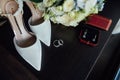 Wedding set of the bride. Shoes and rings lie next to the wedding bouquet Royalty Free Stock Photo