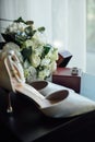 Wedding set of the bride. Shoes and rings lie next to the wedding bouquet Royalty Free Stock Photo