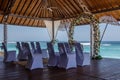 Wedding setup - wedding pergola, flower arch and chairs for guests near the ocean, Bali, Indonesia