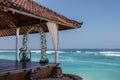 Wedding setup - wedding pergola, flower arch and chairs for guests near the ocean, Bali, Indonesia