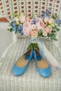 Wedding shoes and bouquet on a white chair Royalty Free Stock Photo