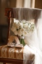 wedding shoes and bride\'s bouquet on a vintage chair Royalty Free Stock Photo