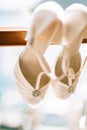 Wedding shoes of the bride at a window. Royalty Free Stock Photo