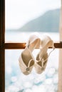Wedding shoes of the bride at a window. Royalty Free Stock Photo