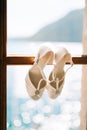 Wedding shoes of the bride at a window. Royalty Free Stock Photo