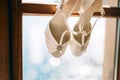 Wedding shoes of the bride at a window. Royalty Free Stock Photo