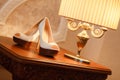 Wedding shoes at the hotel on a wooden table. Royalty Free Stock Photo
